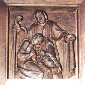 Oben links: Josef hält seinen Mantel schützend über Maria und Jesuskind in der Krippe